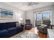 Relaxing living room featuring a comfortable blue sofa, two recliners, and sliding glass doors to the balcony at 9501 Shore Dr. # 135, Myrtle Beach, SC 29572