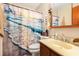 Bathroom with a vanity, toilet, decorative shower curtain, and a towel rack at 951 Plantation Dr. # F1, Little River, SC 29566