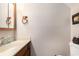 Half bathroom features a vanity with sink, toilet, and decorative accents at 951 Plantation Dr. # F1, Little River, SC 29566