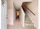 Bright entryway with tiled floors leading to carpeted stairs and a hallway with closet and view to the living room at 951 Plantation Dr. # F1, Little River, SC 29566