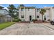 Inviting townhouse featuring a neatly landscaped front yard, a patio set, and convenient parking space at 951 Plantation Dr. # F1, Little River, SC 29566