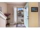 Bright foyer with tile flooring, a painted door, decorative accents, and a view of the townhouse complex at 951 Plantation Dr. # F1, Little River, SC 29566