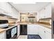 Efficient kitchen offers white cabinetry, neutral countertops and modern appliances at 951 Plantation Dr. # F1, Little River, SC 29566