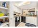 Bright kitchen features white cabinets and appliances plus a view to the living area at 951 Plantation Dr. # F1, Little River, SC 29566