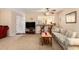Open living room with view to kitchen bar, ceiling fan, comfortable seating, and neutral decor at 951 Plantation Dr. # F1, Little River, SC 29566