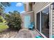 Patio with sliding glass doors, blue accent door and chair at 951 Plantation Dr. # F1, Little River, SC 29566