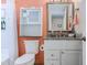 Bathroom featuring a white vanity with granite countertop, framed mirror and combined toilet/shower at 9550 Shore Dr. # 225, Myrtle Beach, SC 29572