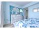 A bedroom with white dresser, a decorative bird statue, and a flat screen television on the wall at 9550 Shore Dr. # 225, Myrtle Beach, SC 29572