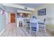 Cozy dining area features wood floors, seating for four, and a breakfast bar looking into the kitchen at 9550 Shore Dr. # 225, Myrtle Beach, SC 29572