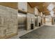 Elevator lobby with three elevators, neutral color palette, and stylish chandelier lighting at 9550 Shore Dr. # 225, Myrtle Beach, SC 29572