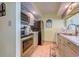 Compact kitchen with stainless steel appliances and grey cabinetry at 9550 Shore Dr. # 225, Myrtle Beach, SC 29572