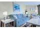 Bright living room with blue sofa, beach-themed decor, and modern furnishings at 9550 Shore Dr. # 225, Myrtle Beach, SC 29572
