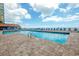 View of the community pool showcasing lounge chairs, a brick paver deck, and clear blue water at 9550 Shore Dr. # 225, Myrtle Beach, SC 29572