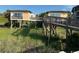 Charming beachfront cottages connected by wooden walkway, surrounded by lush greenery at 5732 N Ocean Blvd., Myrtle Beach, SC 29577
