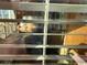 Interior shot through blinds, showcasing a glimpse of living room furniture at 5732 N Ocean Blvd., Myrtle Beach, SC 29577