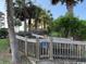 Wooden walkway leading to a private beachfront property, surrounded by palm trees at 5732 N Ocean Blvd., Myrtle Beach, SC 29577