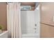 A clean and bright shower and tub combination with white tile and neutral toned shower curtain at 108 Barnacle Ln. # 4, Little River, SC 29566