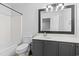 Well-lit bathroom featuring a vanity with dark cabinets and a shower-tub combination at 108 Barnacle Ln. # 4, Little River, SC 29566