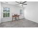 Bright bedroom featuring carpet flooring, a ceiling fan, and natural light from the windows at 108 Barnacle Ln. # 4, Little River, SC 29566