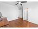 Bright bedroom featuring hardwood floors, ceiling fan, and white walls with a doorway leading to the bathroom at 108 Barnacle Ln. # 4, Little River, SC 29566
