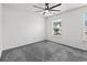 Spacious bedroom with neutral carpet, lots of natural light, and ceiling fan at 108 Barnacle Ln. # 4, Little River, SC 29566