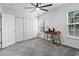 Well-lit bedroom with plush carpeting, ceiling fan, and windows providing ample natural light at 108 Barnacle Ln. # 4, Little River, SC 29566