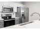 Modern kitchen featuring stainless steel appliances, white countertops, and gray cabinets at 108 Barnacle Ln. # 4, Little River, SC 29566
