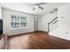 A well-lit living room features hardwood floors, a large window and a gray front door with a staircase at 108 Barnacle Ln. # 4, Little River, SC 29566