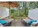 A tranquil patio scene with two lounge chairs, vibrant blue pillows and lush green foliage in the background at 108 Barnacle Ln. # 4, Little River, SC 29566