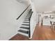 An interior view of a staircase leading to the second floor, adjacent to the kitchen area at 108 Barnacle Ln. # 4, Little River, SC 29566