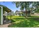 Backyard featuring a large tree, green grass, and a covered patio at 1100 Rosetta Dr., Conway, SC 29526