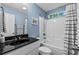 Bathroom features a tub/shower combo, a single sink vanity with black marble top, and light blue walls at 1100 Rosetta Dr., Conway, SC 29526