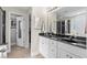 Modern bathroom features a double vanity, black countertops, and tiled floors at 1100 Rosetta Dr., Conway, SC 29526