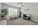 Bedroom featuring a window, gray carpet, ceiling fan, white desk, and gray cushioned stools at 1100 Rosetta Dr., Conway, SC 29526