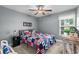Bedroom with a bed with patriotic quilt, a ceiling fan, and a window overlooking the backyard at 1100 Rosetta Dr., Conway, SC 29526