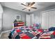 Bedroom featuring patriotic decor, a ceiling fan, and closet with white bi-fold doors at 1100 Rosetta Dr., Conway, SC 29526