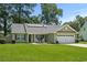 Well-maintained home with green lawn, solar panels, and American flag at 1100 Rosetta Dr., Conway, SC 29526