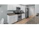 The kitchen features stainless appliances, light wood floors, granite countertops, and white cabinets at 1100 Rosetta Dr., Conway, SC 29526