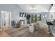 Bright living room boasts vaulted ceiling, ceiling fan, TV, and sliding glass door at 1100 Rosetta Dr., Conway, SC 29526