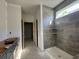 Modern bathroom featuring a tiled shower with built-in shelves, awaiting final fixtures and completion at 1221 Lady Bird Way, North Myrtle Beach, SC 29582