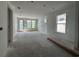 Bright, unfinished living room with multiple windows and a glass door, awaiting personal touches and furniture at 1221 Lady Bird Way, North Myrtle Beach, SC 29582