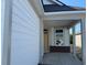 Welcoming covered porch with brick accents, a stylish front door and window, ready for finishing touches at 1221 Lady Bird Way, North Myrtle Beach, SC 29582