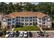 Three-story condo building boasting a brown roof, multi-level balconies and private entrances at 125 S Shore Dr. # 204, Longs, SC 29568