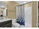 Bathroom featuring a vanity, toilet, and shower/tub with shower curtain at 125 South Shore Dr. # 204, Longs, SC 29568