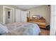 Bedroom featuring a queen bed, dresser with television and interior doorway at 125 South Shore Dr. # 204, Longs, SC 29568