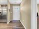 Bright entryway with a white door, neutral walls, wood-look flooring, and stainless steel refrigerator at 125 South Shore Dr. # 204, Longs, SC 29568
