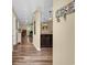 Inviting hallway with wood flooring, nautical decor, and partial view of the living room and kitchen at 125 South Shore Dr. # 204, Longs, SC 29568