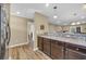 Stylish kitchen with stainless steel appliances, dark wood cabinets, and a view of the living area at 125 South Shore Dr. # 204, Longs, SC 29568