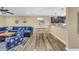 Bright living room featuring a blue sectional, nautical accents, wood-look flooring, and dining area at 125 South Shore Dr. # 204, Longs, SC 29568