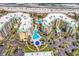 The aerial perspective captures pools and palm trees amid oceanfront condo buildings and sunny beach at 139 S Dunes Dr. # 304, Pawleys Island, SC 29585